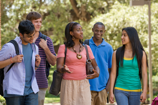 College Teacher Walking  with Students  on Campus