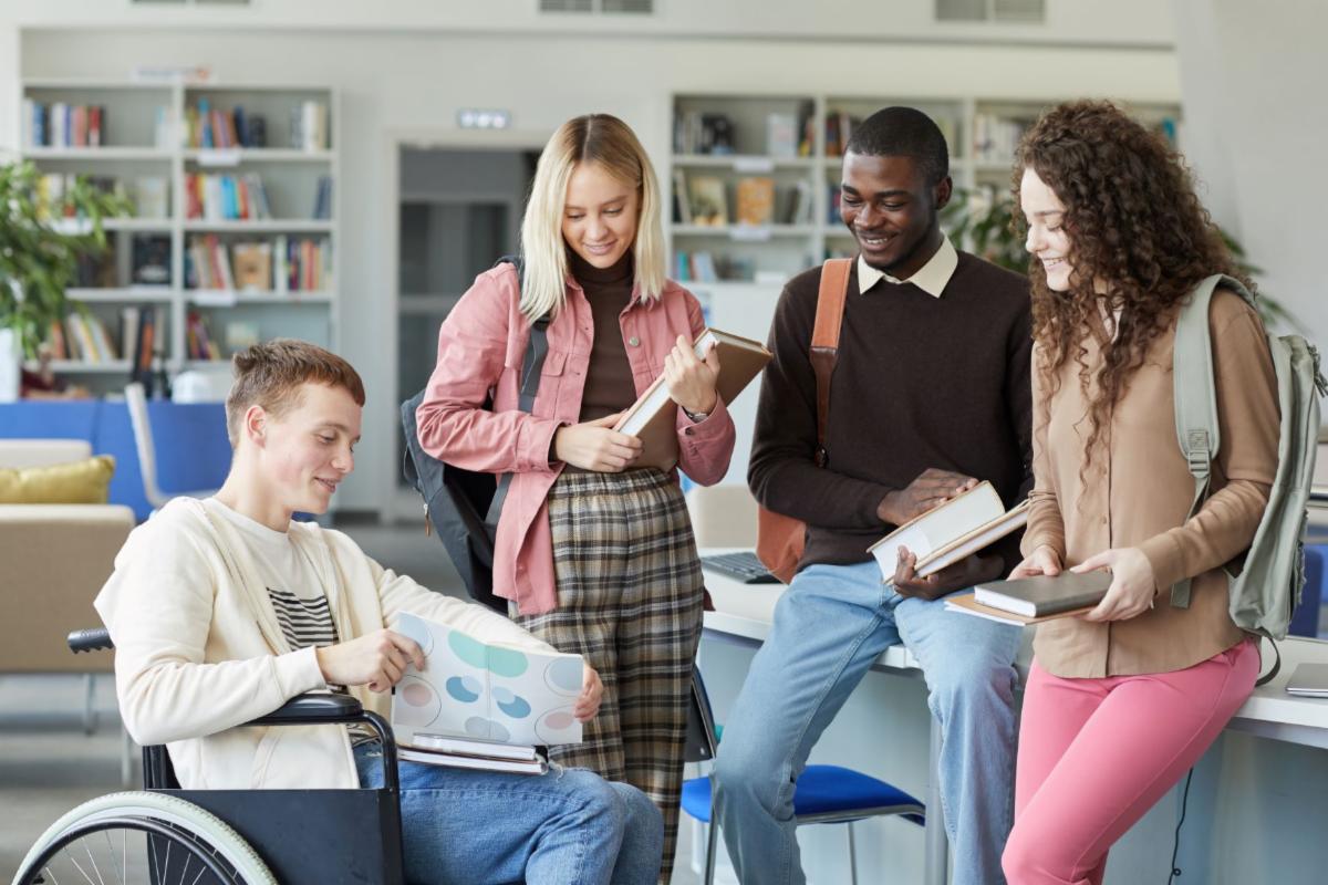 diverse higher education level students holding their books and chatting