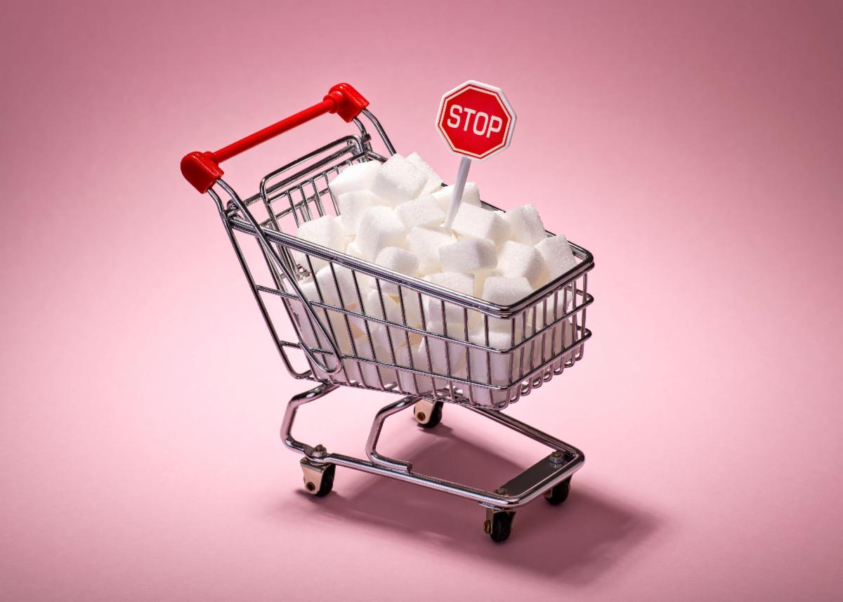 A full shopping cart figurine with stop sign sticking out