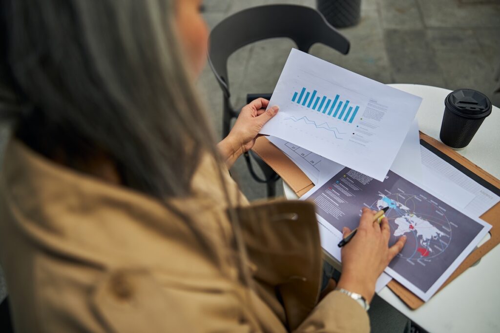 an over the shot shot of a woman looking down at a page of a research report