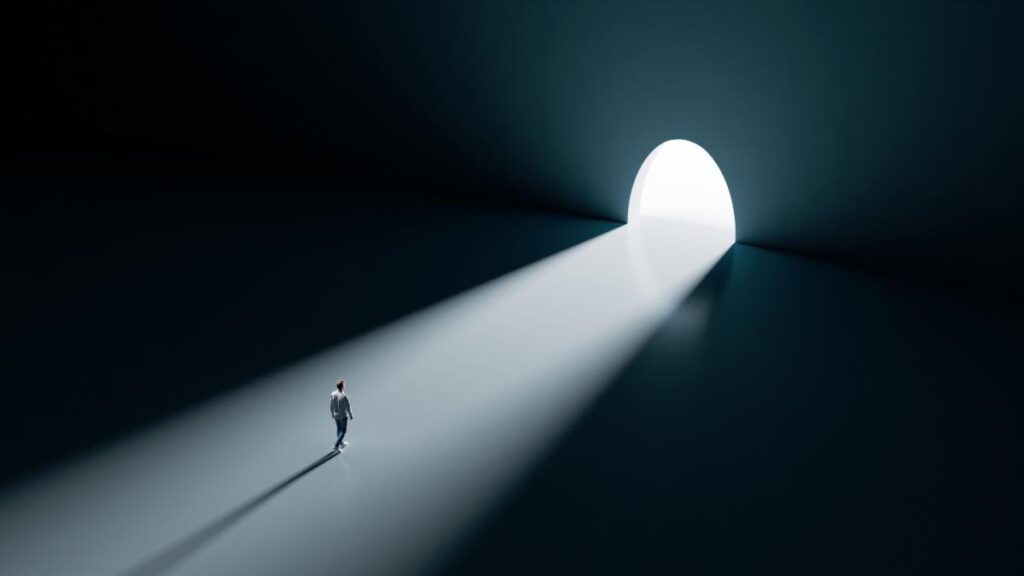 dark room with light pouring through an open doorway